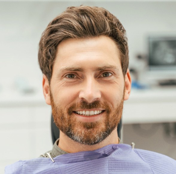 Male dental patient sitting and smiling
