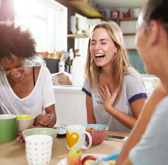 Woman with dental sealants laughing with friends