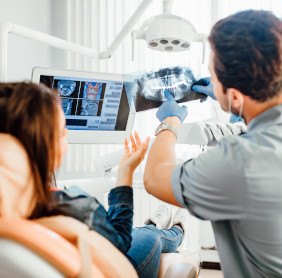 Dentist and patient looking at X-ray